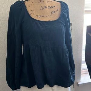 Pretty turquoise colored light weight blouse.